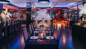 A long dining table with chairs, candles, and a decorative centerpiece. - Hotel Soray (Wieliczka)