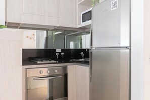 A modern kitchen with stainless steel appliances, a microwave, and a refrigerator. - MOT Zapiola (Buenos Aires)