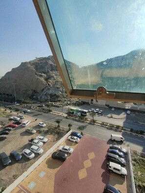 A parking lot with cars and a building in the background.