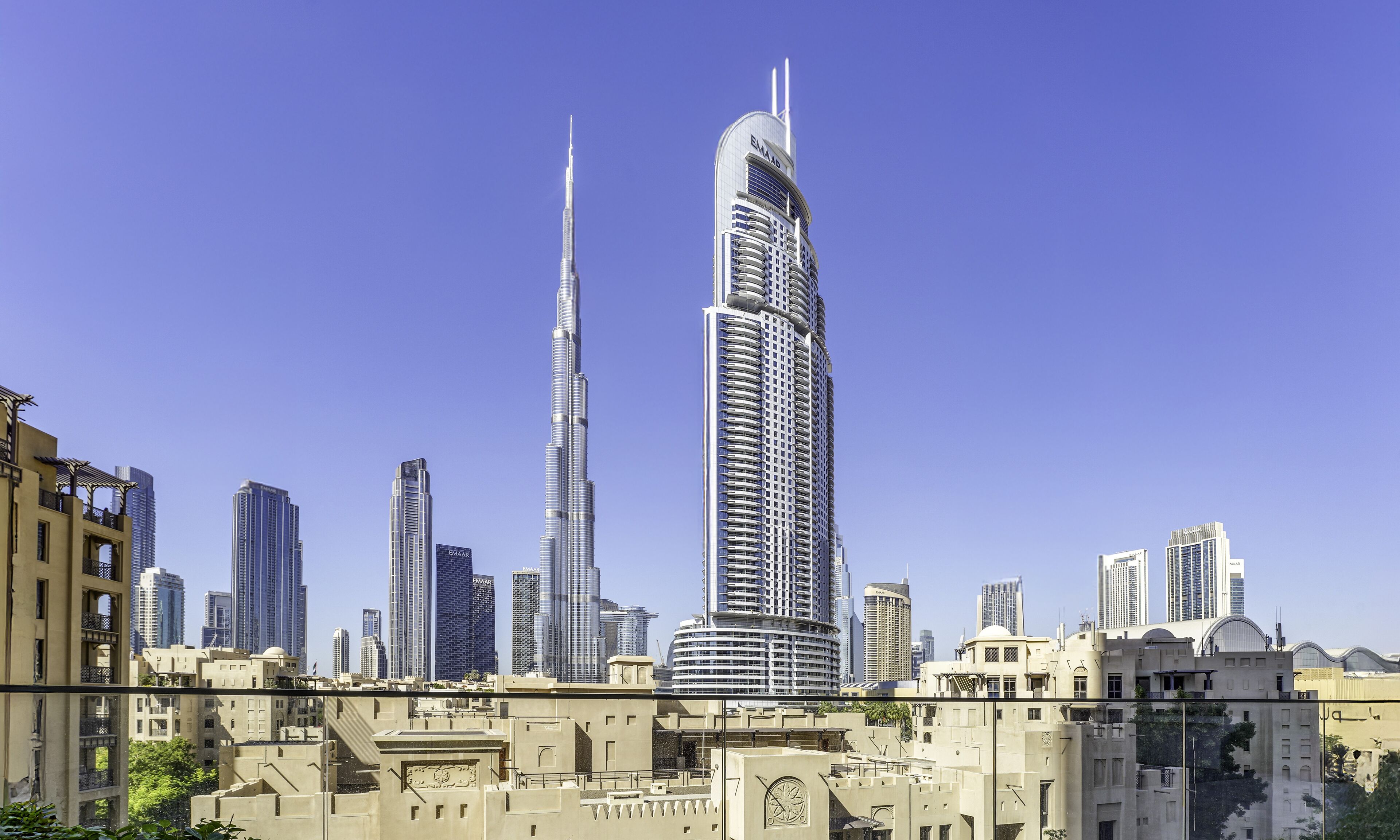 A cityscape with prominent skyscrapers, including the Burj Khalifa and Emaar properties.
