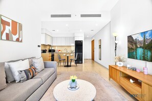 Apartment, Balcony, Canal View | Living room | 65-inch Smart TV with digital channels - WYZ RENT|Sleek 1BR in Burj Royale with Canal View (Dubai)