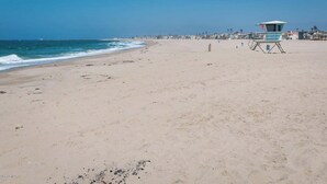 A beach with a lifeguard tower, sandy shore, and ocean waves. - 25% Off Sept 10-12, Walk 2 Beach, Private Jacuzzi! (Oxnard)