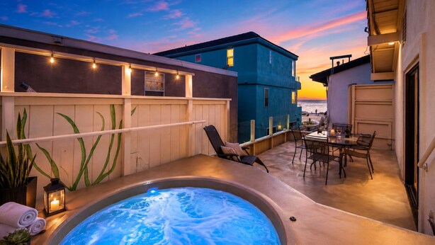 A rooftop patio with a hot tub, outdoor seating, and a view of the sunset. - 25% Off Sept 10-12, Walk 2 Beach, Private Jacuzzi! (Oxnard)