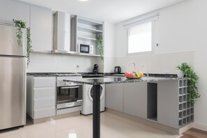 Apartment (C) | Private kitchen | Full-size fridge, microwave, oven, stovetop