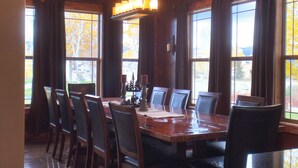 A dining area with a large wooden table, multiple chairs, and a chandelier. - Spacious 5-bedroom house in beautiful Belgrade with WiFi (Belgrade)