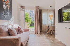 Family Apartment, Courtyard View, Garden Area | Living area | 45-inch flat-screen TV with cable channels - BOUTIQUE HOME (L'Hospitalet de Llobregat)