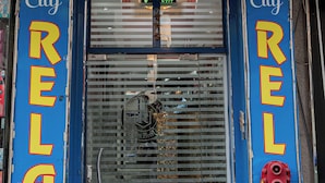 A hotel entrance with a sign reading "City Relax Hotel L.L.C." and a blue door with a "City Relax Hotel" sign on the door frame. - City Relax Hotel (Dubai)
