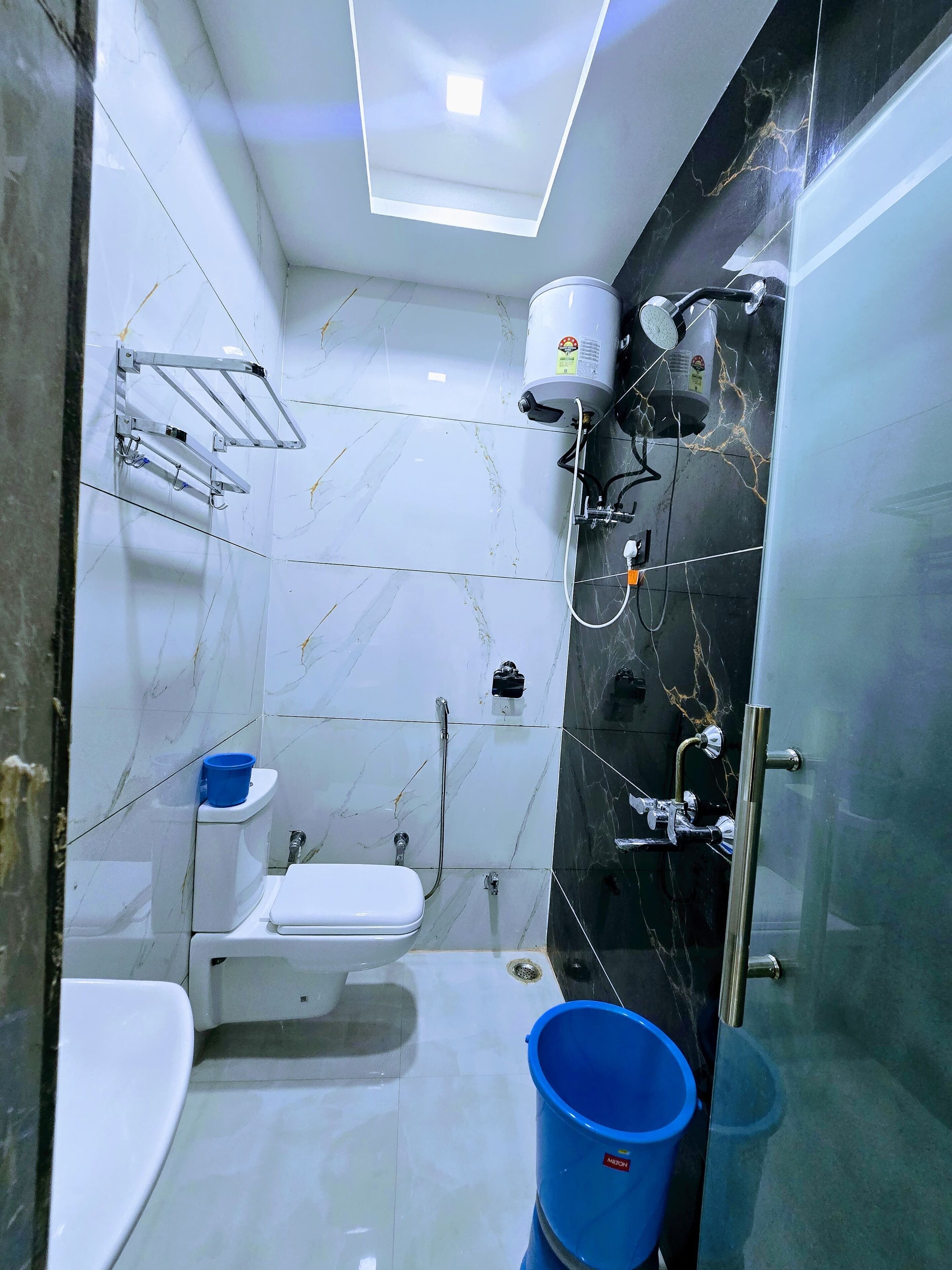 A bathroom with a toilet, bidet, and shower area.