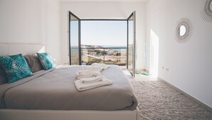 A bedroom with a large bed, a view of the sea, and a modern design. - Villa Bela Vista, beach villa with ocean view  (Atalaia)
