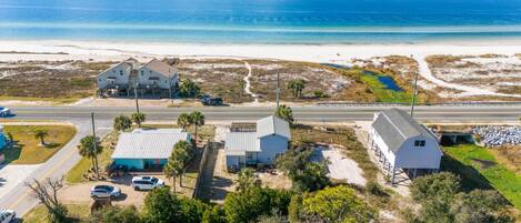 A coastal property with a large house, a smaller building, and a dock.