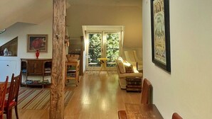 Un vaste espace de vie doté d’un haut plafond, de parquet et d’une grande fenêtre qui laisse entrer la lumière naturelle.