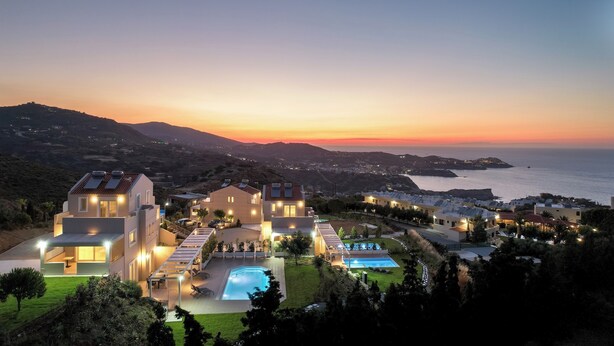 A modern villa with a swimming pool, multiple bedrooms, and a view of the sea at sunset.