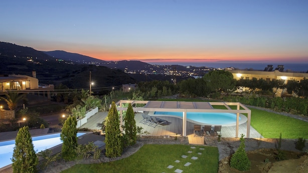 A modern house with a swimming pool, surrounded by a well-maintained lawn and trees. - Blue Hills Villas by Estia, Green 3 (Ammoudi)