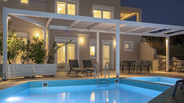 A swimming pool with a covered patio area, outdoor seating, and a stone wall. - Blue Hills Villas by Estia, White 3 (Ammoudi)