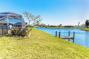 Enjoy serene lakeside views and relax on the wooden dock.