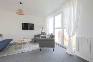 Apartment, Balcony, River View | Living area | Smart TV