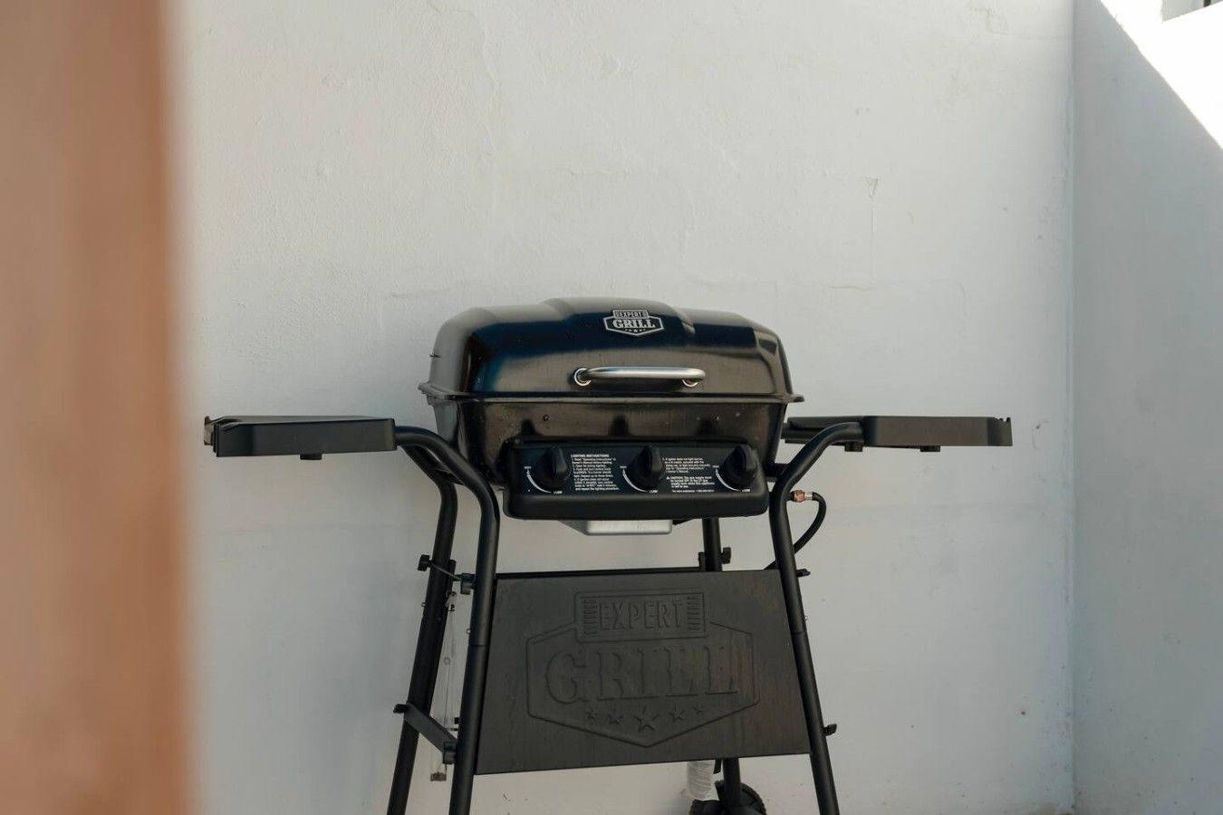A portable grill with a control panel and a brand name on the side.