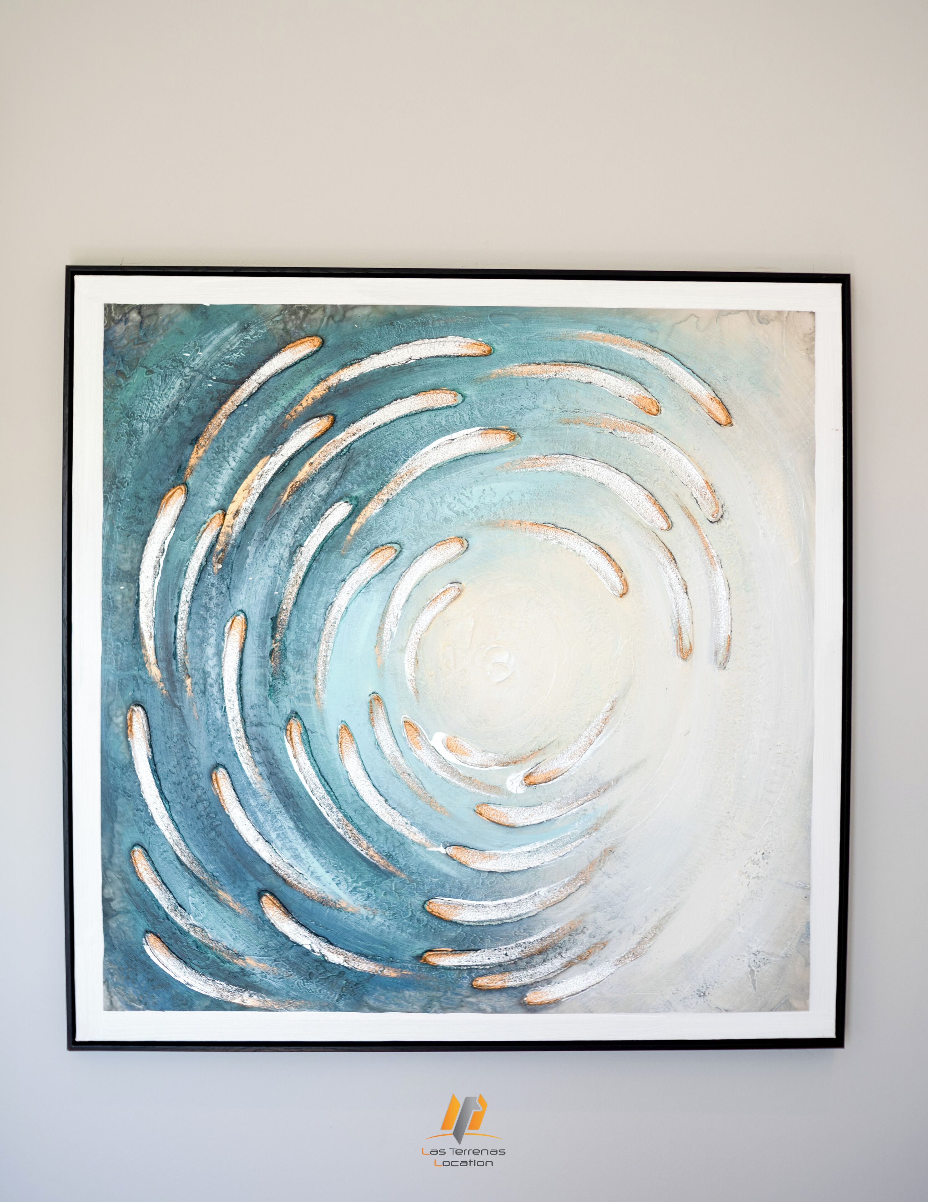 A framed abstract painting with swirling patterns and a central white area.