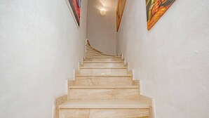 A marble staircase leading to a landing with a ceiling light. - Luvi Maison - Affitti Brevi Italia (Terrazzano)