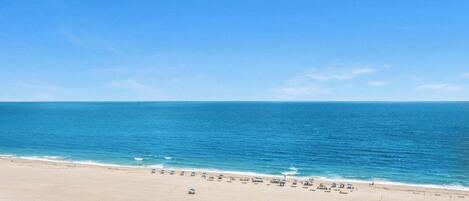 On the beach, sun loungers, beach towels