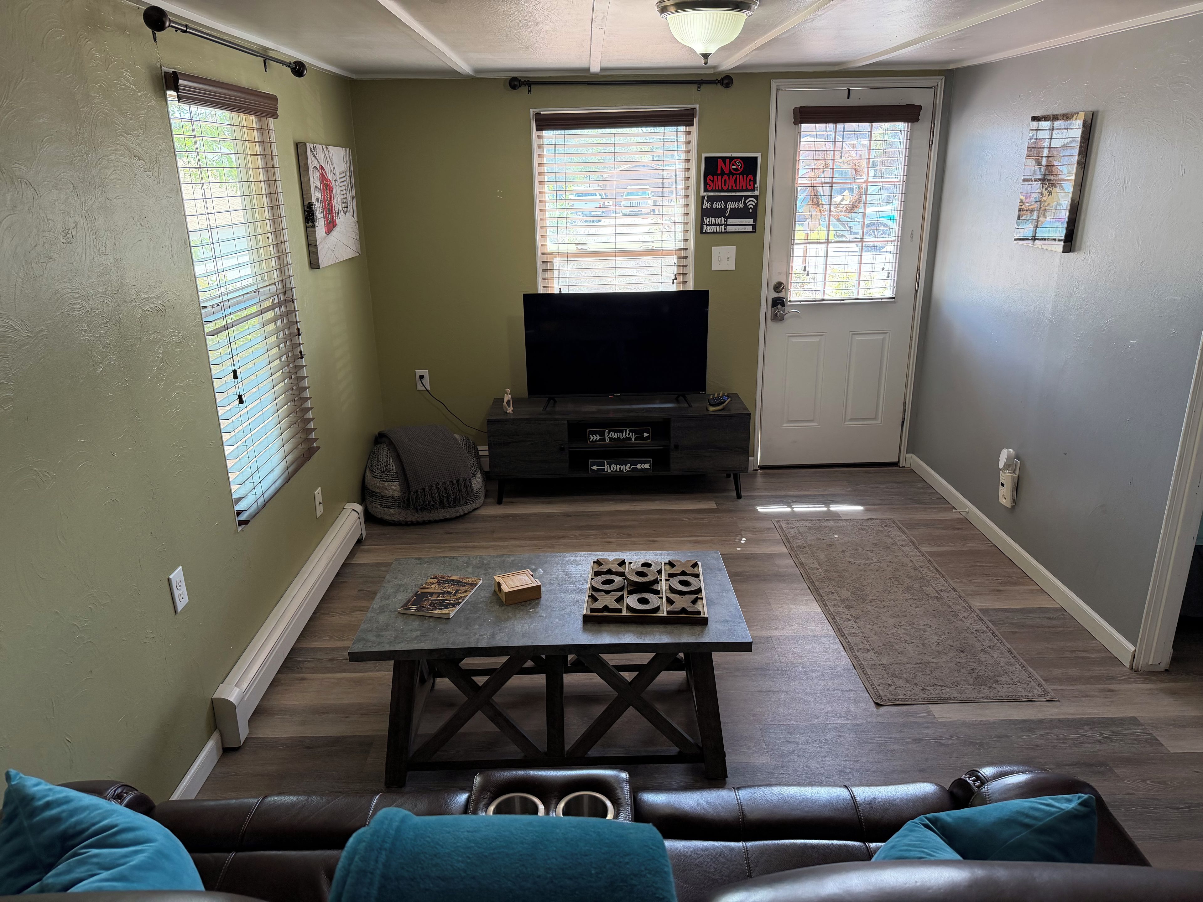 A living room with a television, a coffee table, and a sofa.