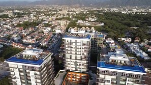 A high-rise building with multiple balconies and a rooftop pool. - Paradise Escape, Life is Good! (Puerto Vallarta)