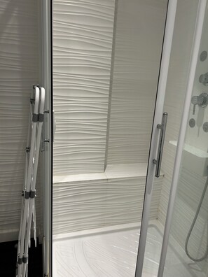 Shower, hair dryer, towels, toilet paper