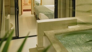 Ein Hotelzimmer mit Bett, Bad und einem kleinen Poolbereich.