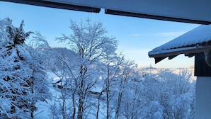 A snowy landscape with trees and a building in the background. - FEWO in the vacation park Oberallgäu with gr. Pool, bed linen, towels, final cleaning (Missen-Wilhams)