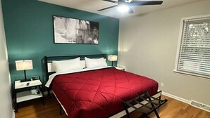 A bedroom with a bed, two bedside tables, a ceiling fan, a window with blinds, and a wall-mounted artwork. - 3 Bed 1.5 Bath Pet Friendly Apt (Columbia)