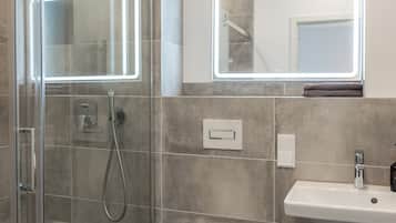 Shower, hair dryer, towels, toilet paper