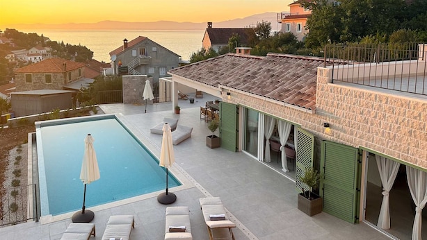 A rooftop pool area with lounge chairs and a view of the sea. - Villa Sea Whisper - location and charm by MyWaycation (Splitska)