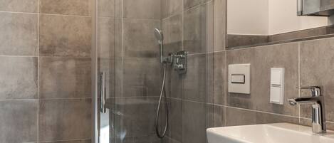 Shower, hair dryer, towels, toilet paper