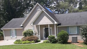 A single-story house with a front porch, a covered entryway, and a small front yard. - Cute House on Lake Hartwell- Dock Access!
PETS ALLOWED! (Townville)