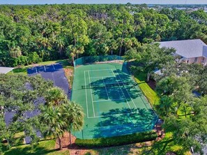 Enjoy a game of tennis surrounded by lush greenery and scenic views.
