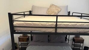 A bunk bed with a lower bed and two nightstands. - Spacious Stay for 16 - Central Fort Worth (Fort Worth)