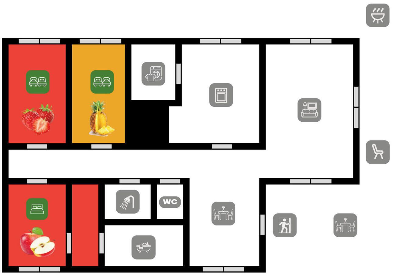 A hotel layout with a kitchen, dining area, WC, and a room with a bed.