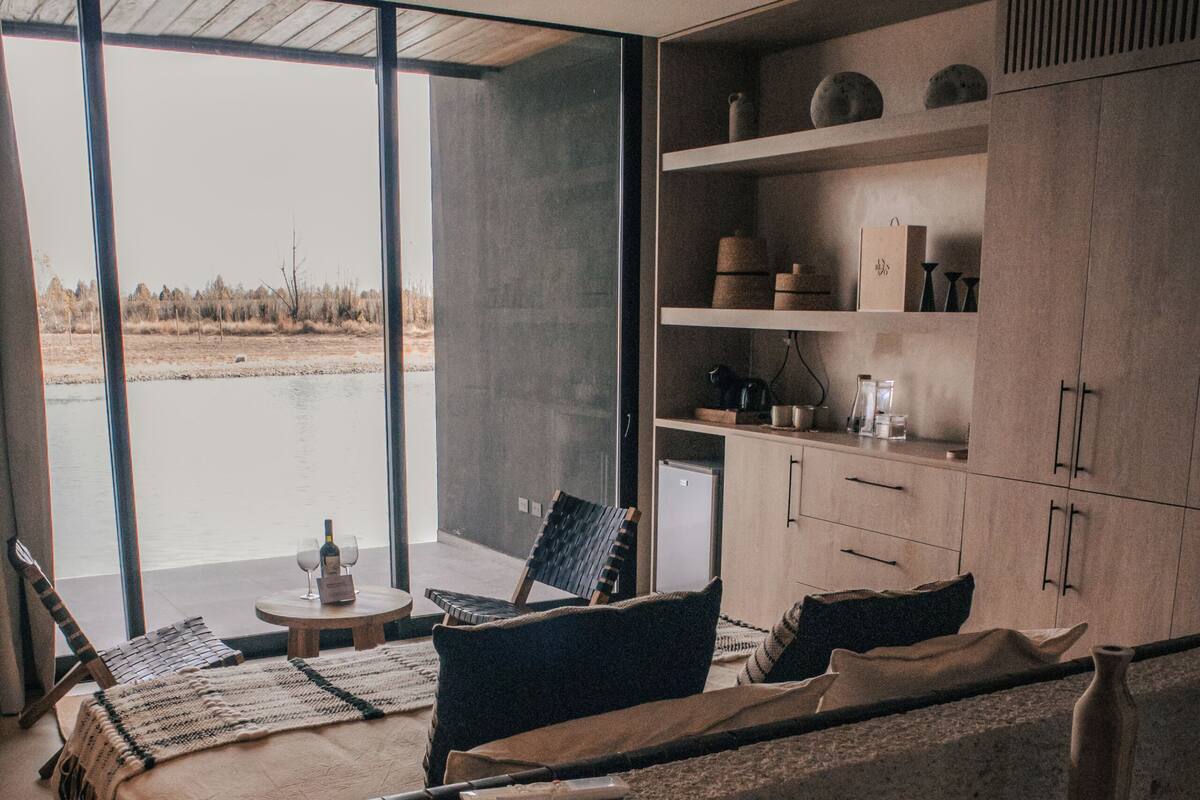 A modern interior with a large bed, a dining area, and a kitchen.