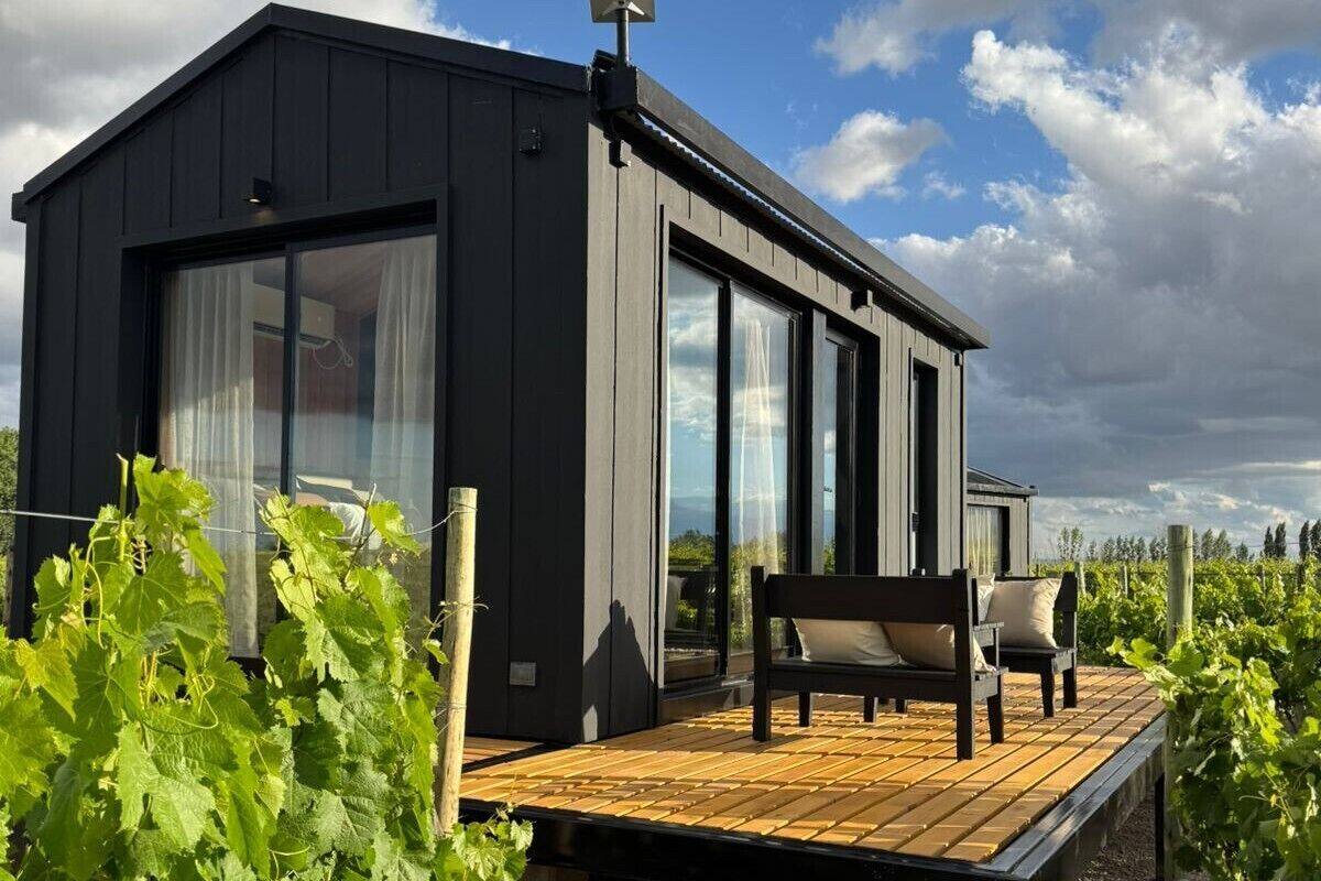 A modern building with large windows and a wooden deck.
