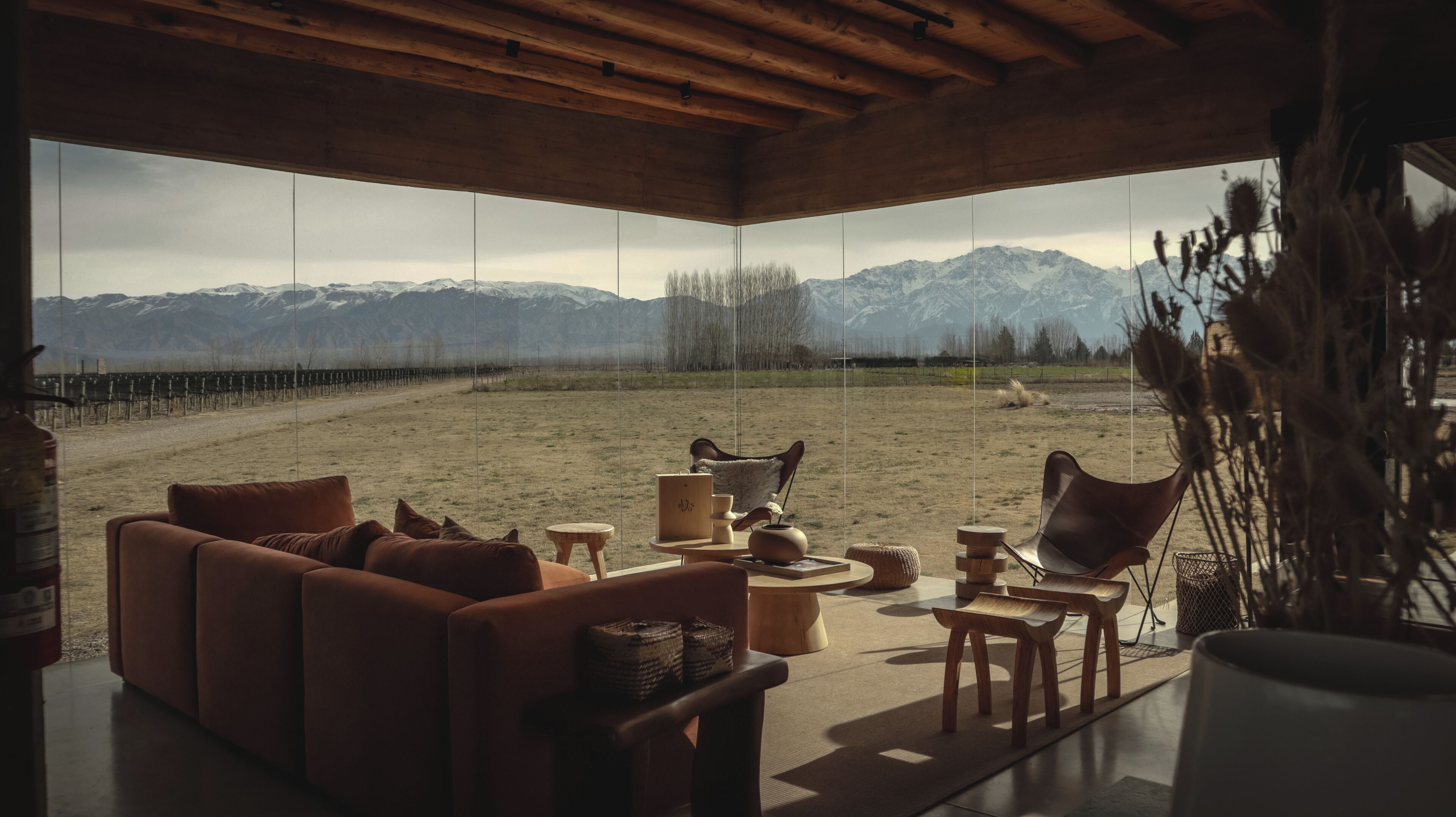 A modern interior with a large window overlooking a mountainous landscape.