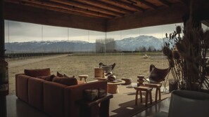 A modern interior with a large window overlooking a mountainous landscape. - Finca Boutique Un Buen Año (Eugenio Bustos)