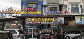 A building with signs for 'Hotel Bambu Kuning' and 'Giant's Gym'. - Hotel Bambu Kuning (Bandar Lampung)