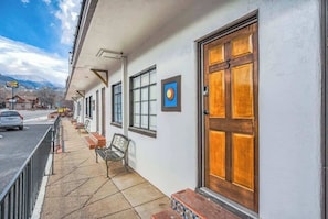 Welcome to the hotel, featuring a clean exterior with a simple entrance and comfortable seating area.