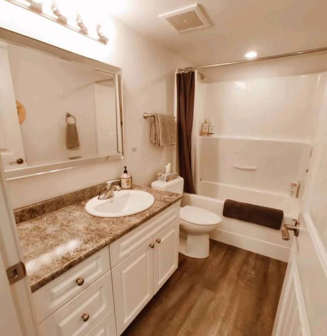 Un baño con lavamanos, inodoro y bañera.