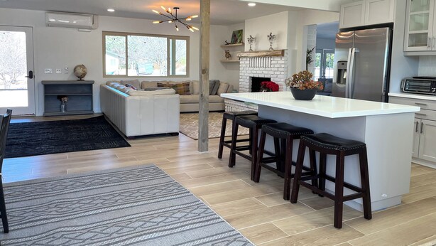 A modern kitchen with a central island, bar stools, a built-in oven, and a refrigerator. - Apple Farm Paradise in Julian (Julian)