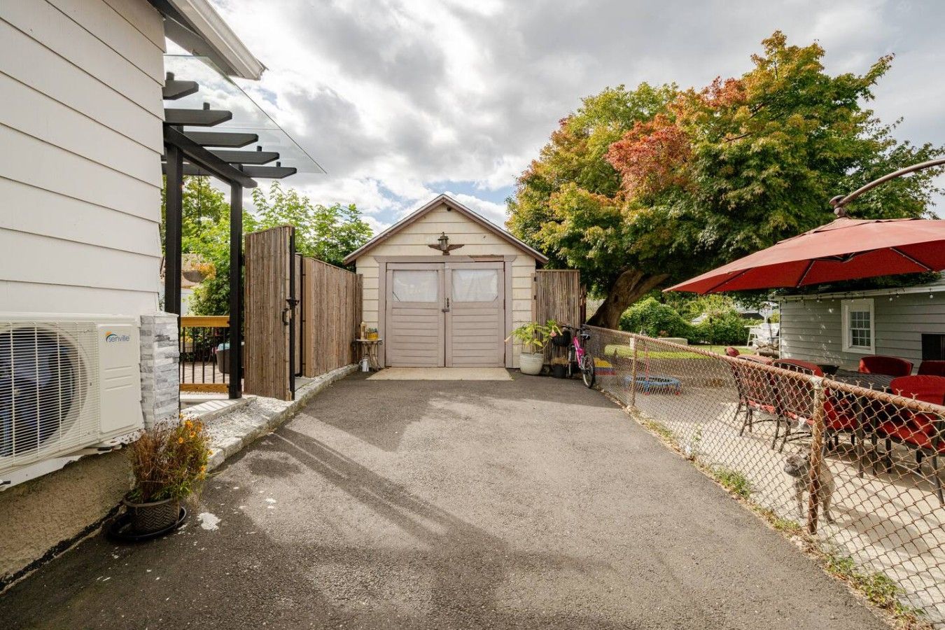A residential property with a garage, a covered patio area, and a fenced backyard.