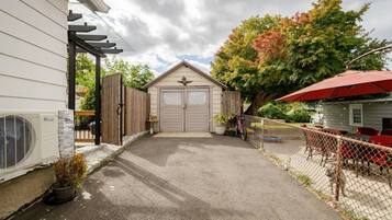 A residential property with a garage, a covered patio area, and a fenced backyard.