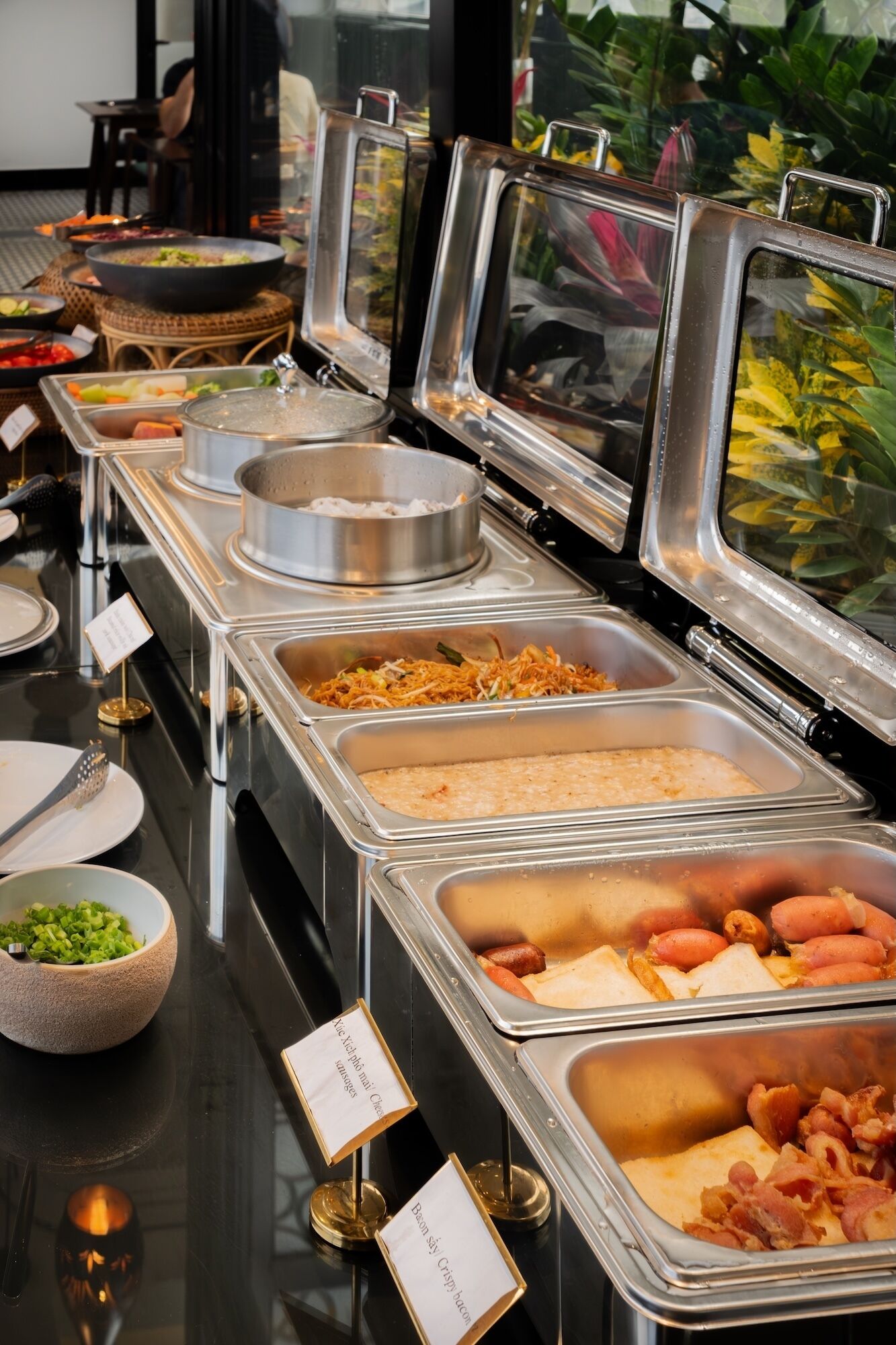 A buffet with various food options including salads, meats, and vegetables.