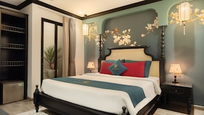 A neatly arranged bedroom with a large bed, bedside tables, and a wardrobe. - Bliss Signature Hotel (Hanoi)