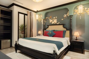 A neatly arranged bedroom with a large bed, bedside tables, and a wardrobe. - Bliss Signature Hotel (Hanoi)